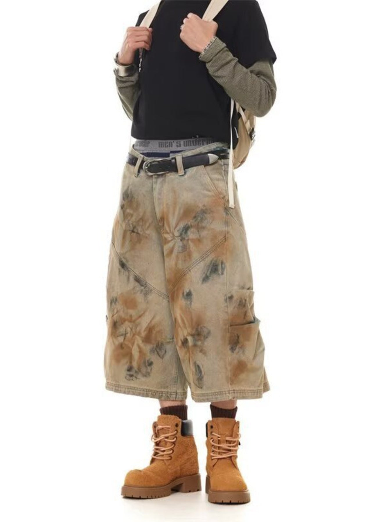 Model wearing camouflage cargo shorts and brown boots- DEA Collection